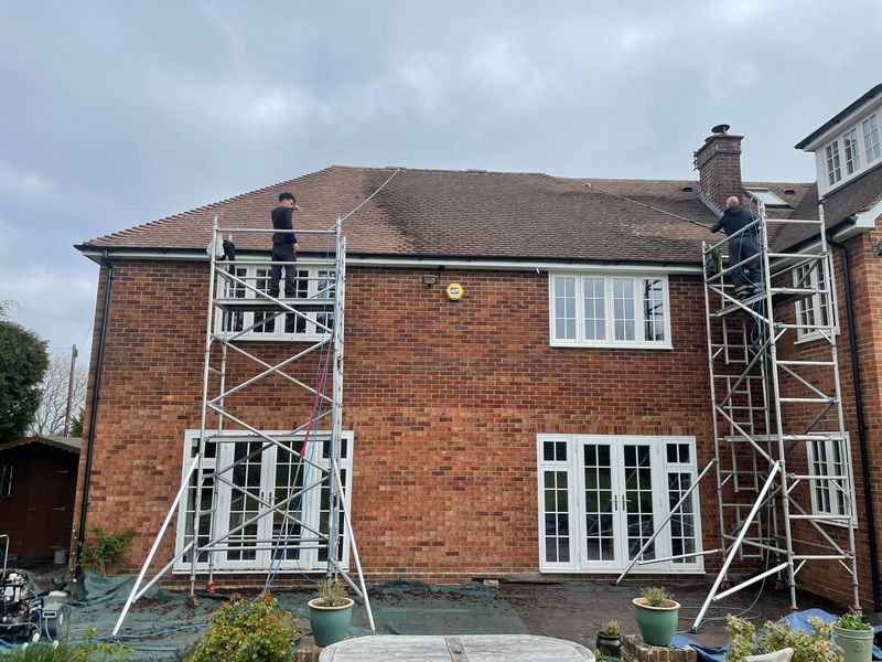 Roof cleaning carried out safely from scaffold towers by The Roof Moss Cleaners in Rushden